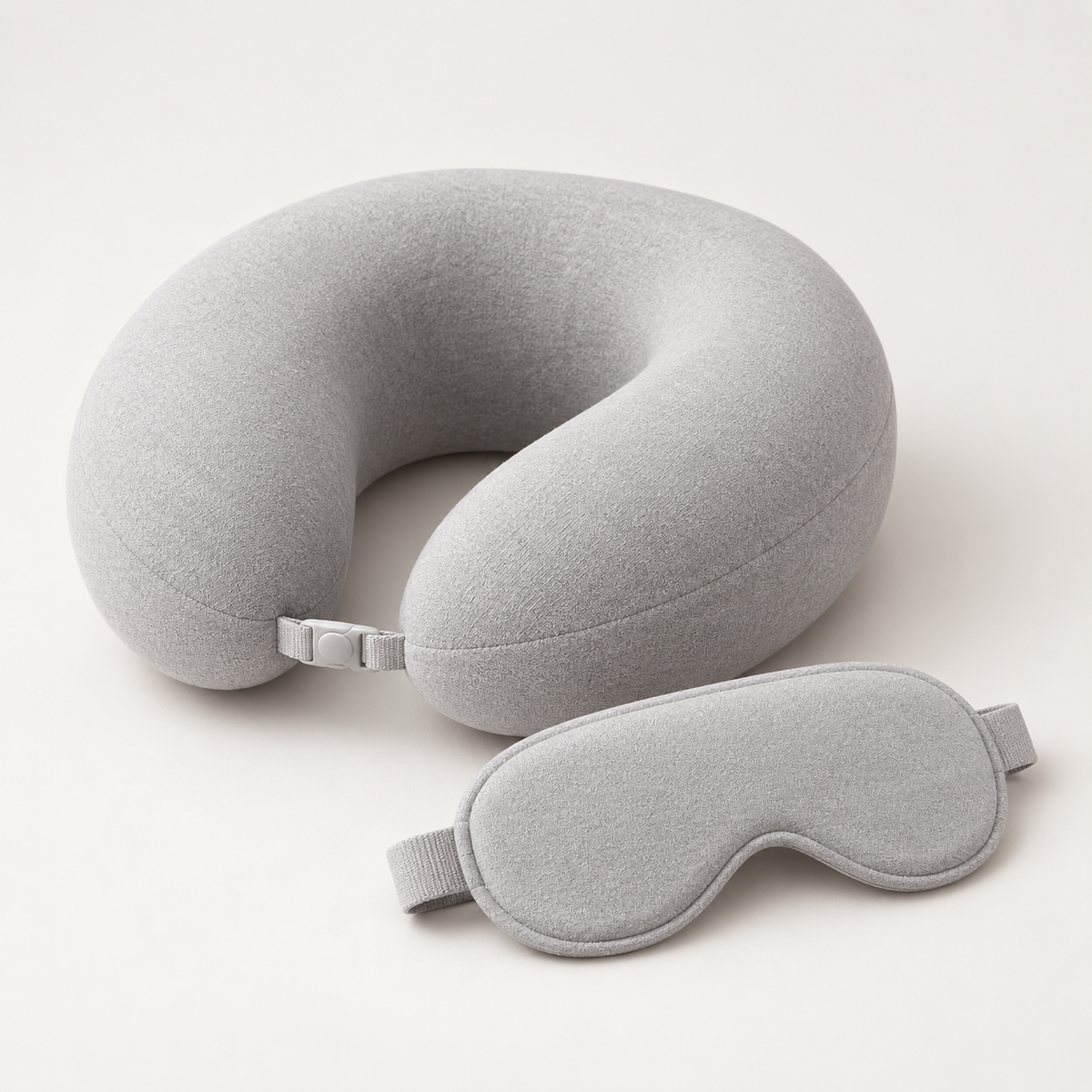 Gray memory foam travel neck pillow with matching sleep eye mask