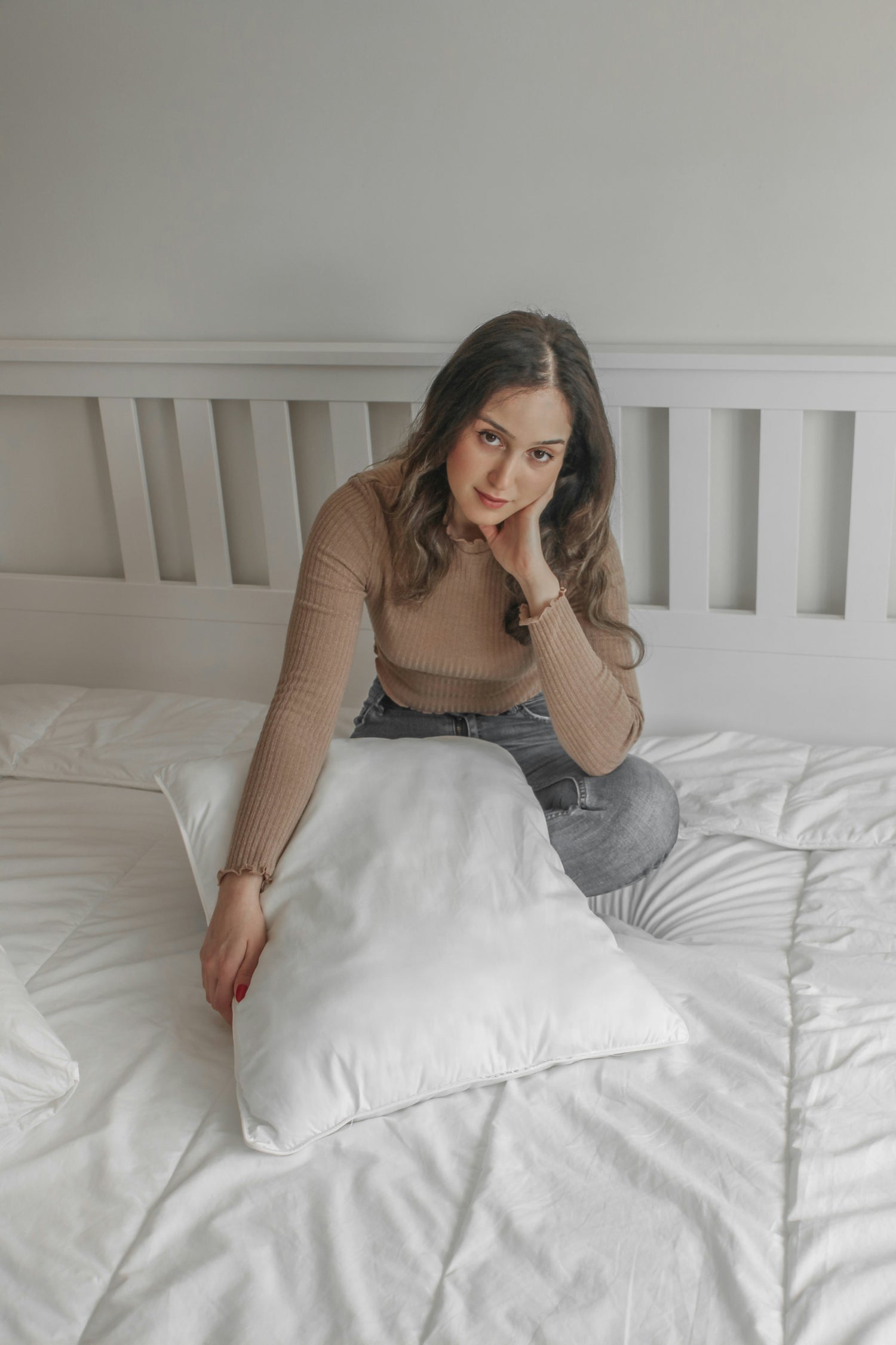 Woman with pillow on bed